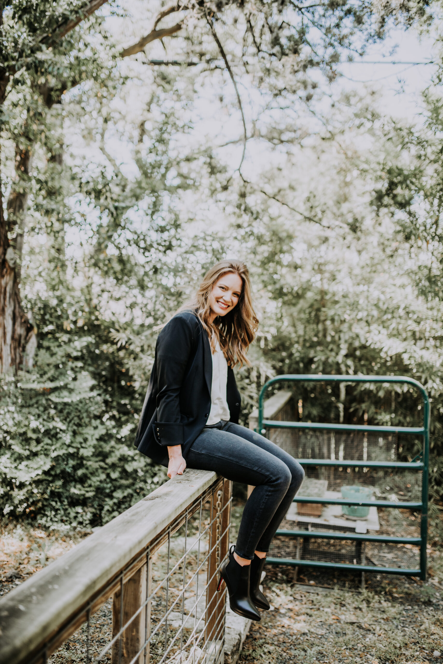 Alyssa sitting on a fence